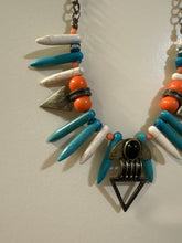 Load image into Gallery viewer, Bohemian-Style Statement necklace featuring tribal-inspired triangle pendants, pointed beads in white and turquoise, and orange accents on a bronze-toned chain

