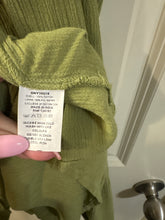 Load image into Gallery viewer, Medium Hint of Blush olive green midi dress featuring a textured crochet V-neck bodice and a tiered, crinkled skirt
