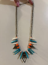 Load image into Gallery viewer, Bohemian-Style Statement necklace featuring tribal-inspired triangle pendants, pointed beads in white and turquoise, and orange accents on a bronze-toned chain
