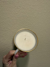 Load image into Gallery viewer, vintage 1940-1970s Fire-King white milk glass teacup, featuring the "Swirl" or "Golden Anniversary" pattern with 22k gold rim trim produced by Anchor Hocking coffee scented candle
